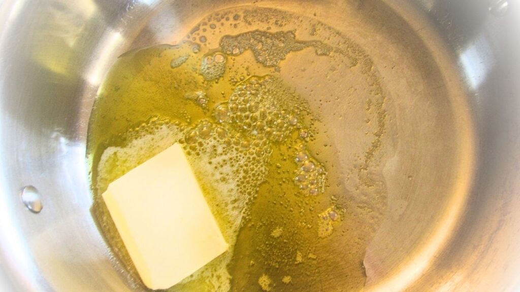 masło topiące się na patelni z oliwą z oliwek